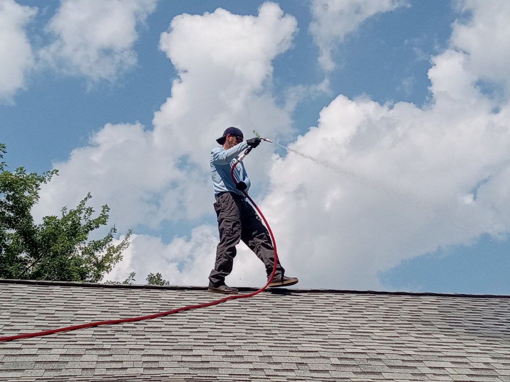 A So Clean Solutions technician executes professional exterior cleaning services.