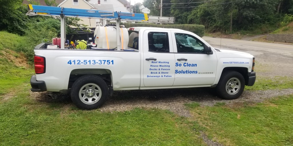 The So Clean Solutions mobile exterior cleaning service unit on a jobsite.