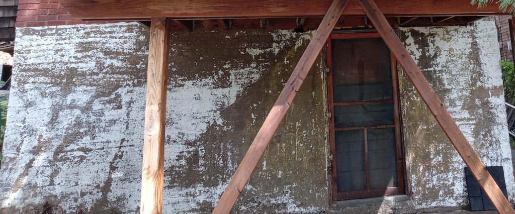 A block wall foundation after paint preparation pressure washing by So Clean Solutions.