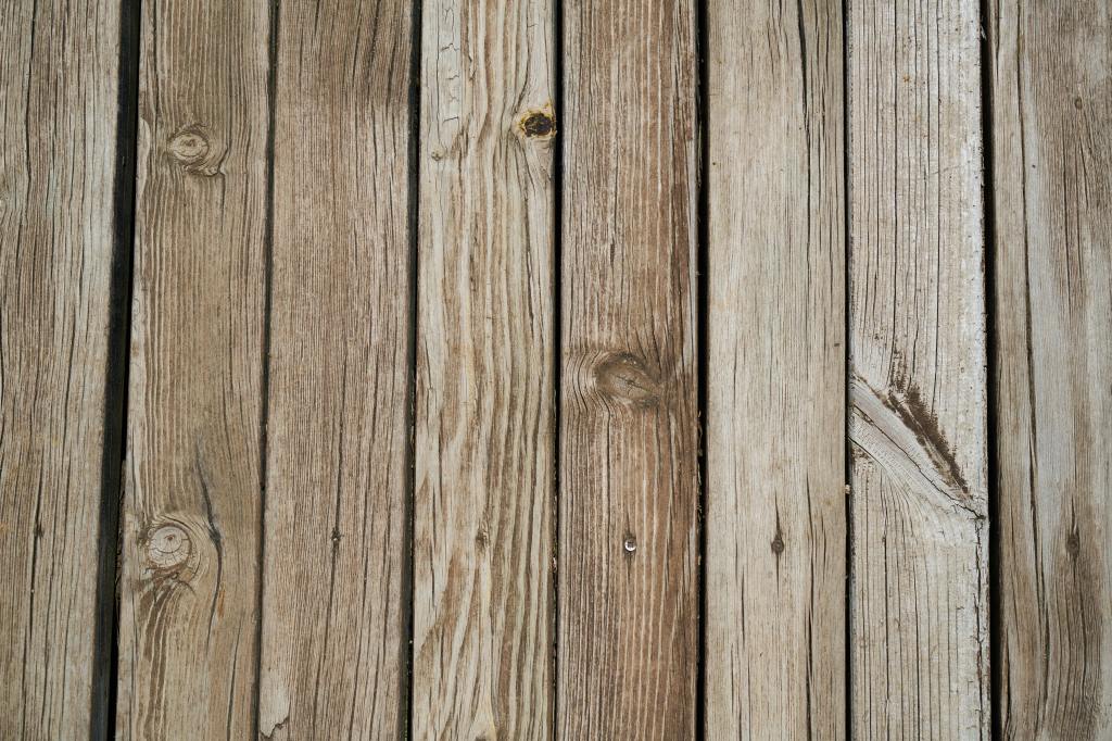 A close-up photo of wood deck planks that have just been power-washed by So Clean Solutions.