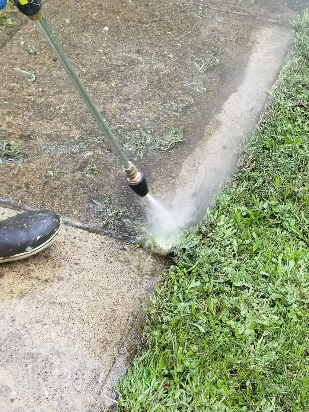 A technician from So Clean Solutions pressure washes a customer's sidewalk in the Pittsburgh area.