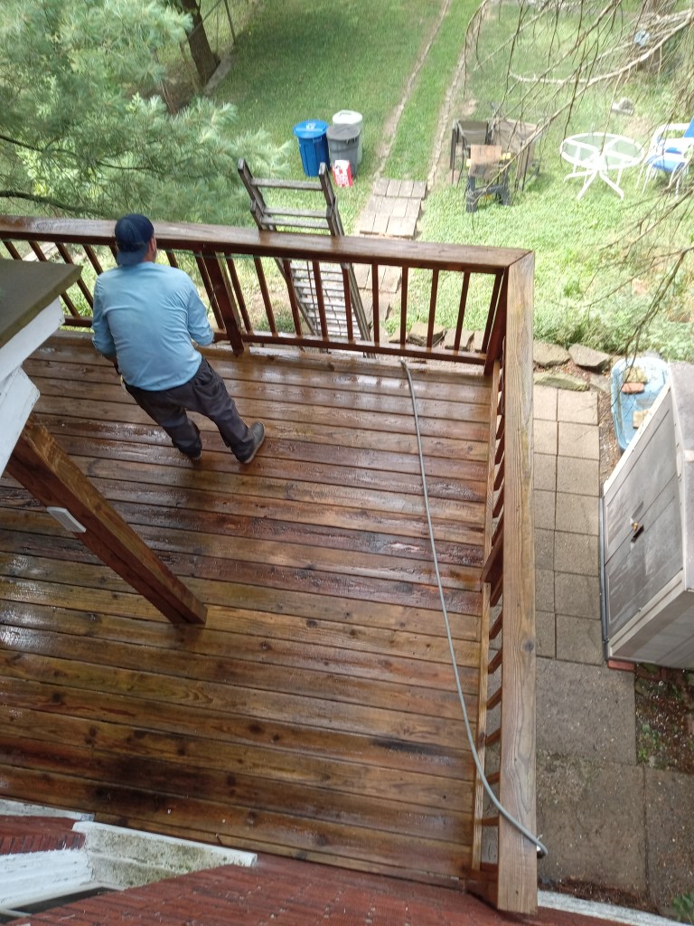 A So Clean Solutions technician performs a restoration cleaning on a wood deck at a Pittsburgh-area home.