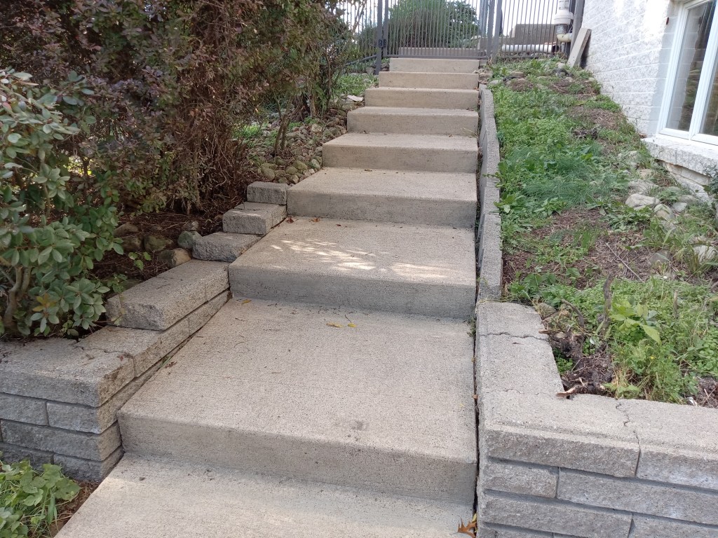 The concrete steps and sidewalk of a Pittsburgh-area home after pressure washing by So Clean Solutions.